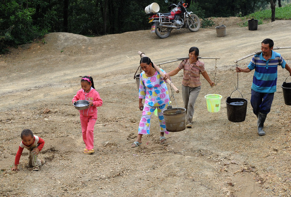 Villagers carry water